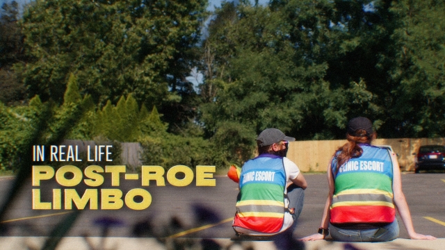 Clinic escorts for abortion patients sit in a parking lot.