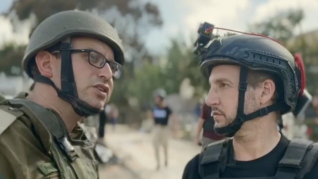 Scripps News war correspondent Jason Bellini, right, talks with a member of the Israel Defense Forces.