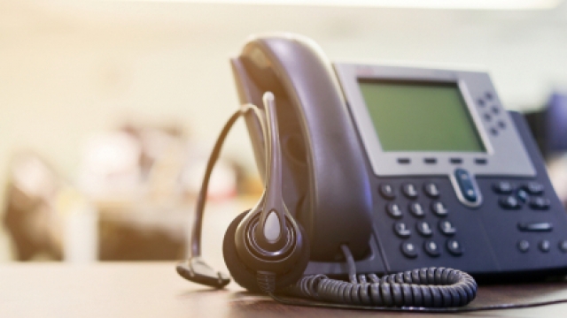 Stock photo of a telephone and headset.