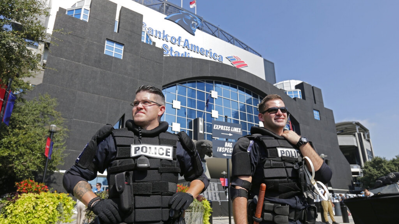 Charlotte-Mecklenburg Police officers stand guard outside Bank of America Stadium before an NFL football game.