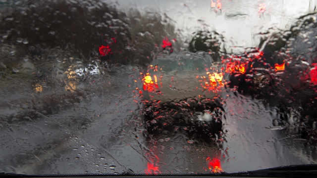 View from a rainy car windshield in traffic