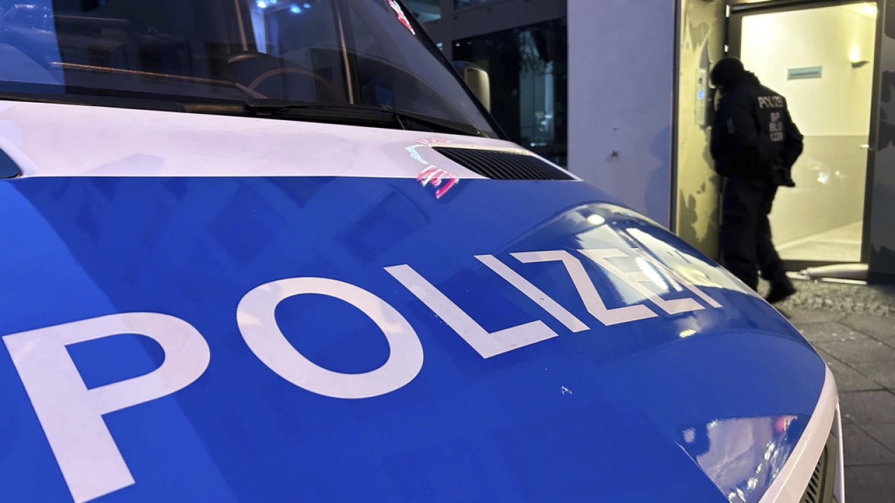 A police vehicle stands on the street during a raid in Berlin-Adlershof in Berlin
