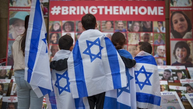 Children look at photographs of kidnapped Israelis