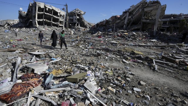 Palestinians visit their houses destroyed in the Israeli bombings.