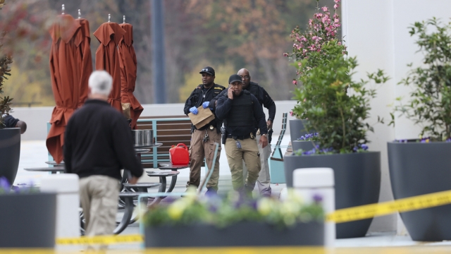 Emergency personnel work the scene after a protester set themself on fire outside the Israeli consulate in Atlanta.