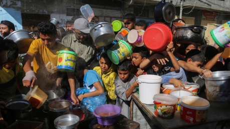 Palestinians crowded together as they wait for food distribution in Rafah, southern Gaza Strip.